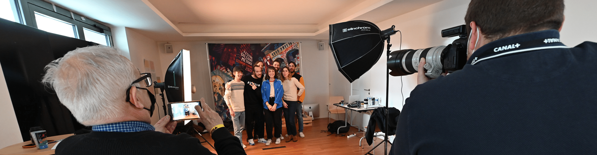 une équipe de film se fait photographier devant le Photocall du festival