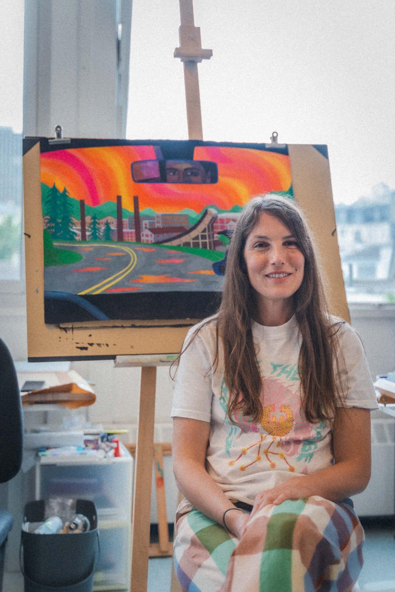 L'illustratrice Marie Larrivé prend la pose devant l'affiche du festival 2025